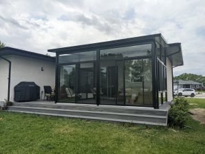 Large black studio sunroom on a composite deck