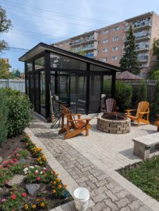 Black free standing sunroom right by the firepit