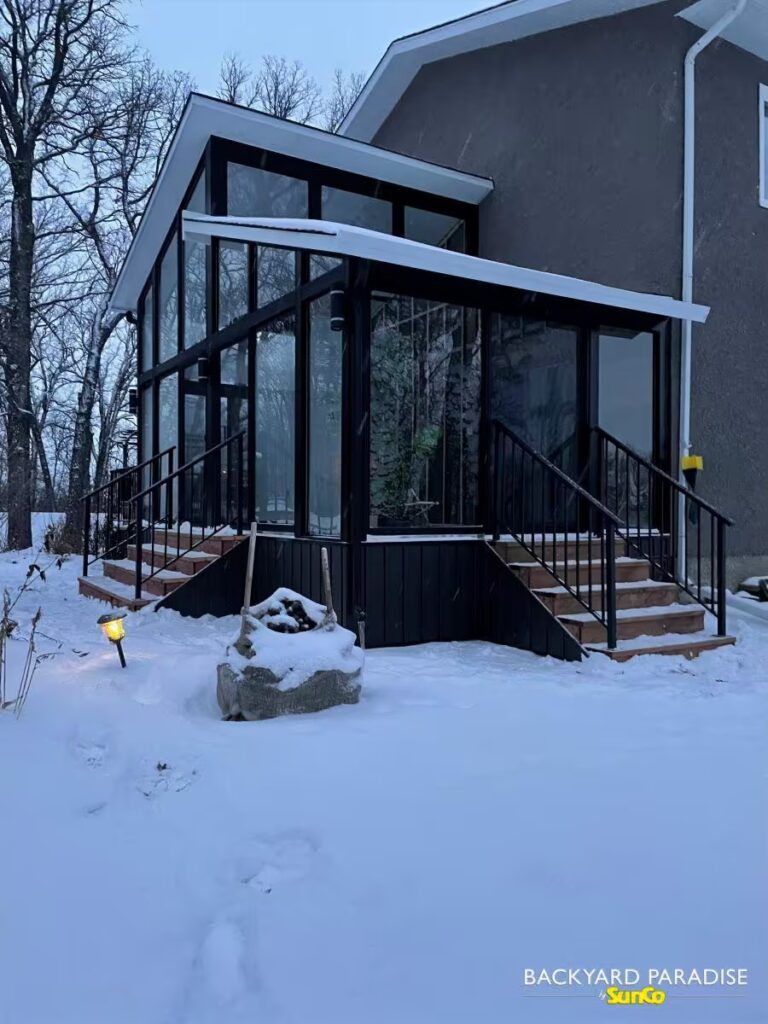 Black split roof line gable sunroom with transoms built in Oak Bluff, Manitoba