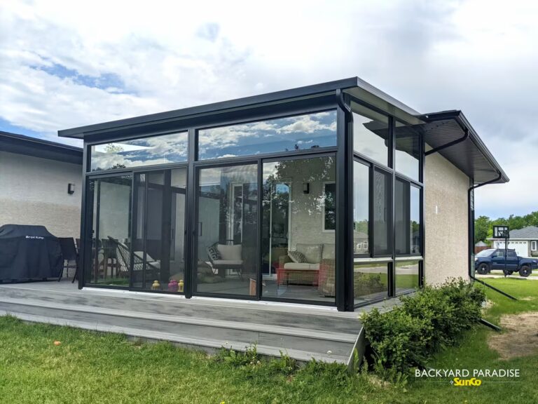 Black studio sunroom on composite deck installed in Stonewall, Manitoba