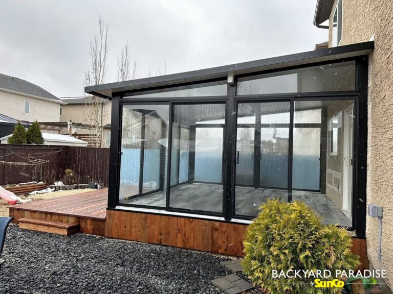Black studio sunroom with treated wood deck built in Transcona, Winnipeg